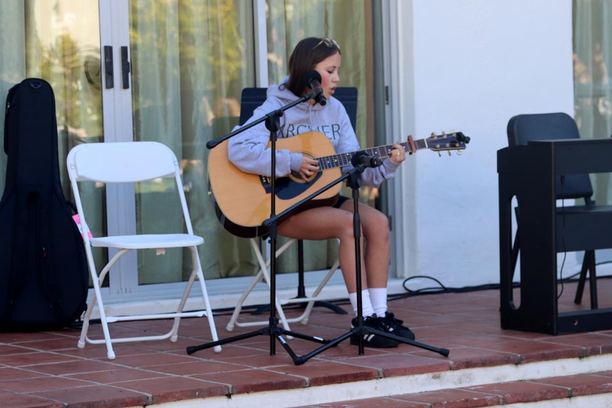 Freshman Lucy Dinerstein performs "Chocolate Milk" by Hospital Bracelet during the SongShare Jan. 16. Dinerstein has been playing the guitar for a few years and is in her own band called Tampopo. "You [are] getting to be up on stage and showcase your talents and passions," Dinerstein said. "You're also getting to feel the community and be within the crowd."