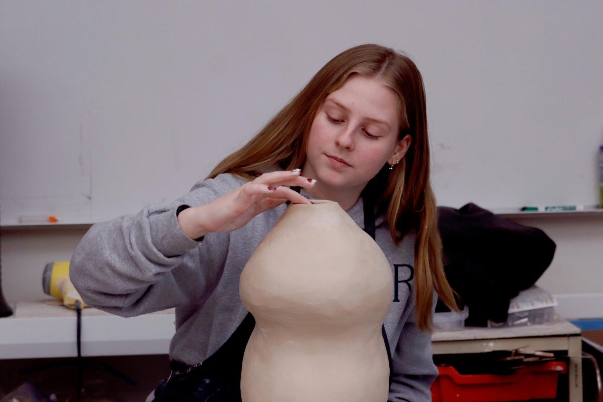 Focused on her work, Charlotte Stein (‘26) uses her hands to sculpt a ceramic piece during class. She chose ceramics as her elective in freshman year and continued to pursue it all four years, as it is one of her favorite hobbies. “I think it's just a really great hobby that has given me a lot of friends and joy,” Stein said.
