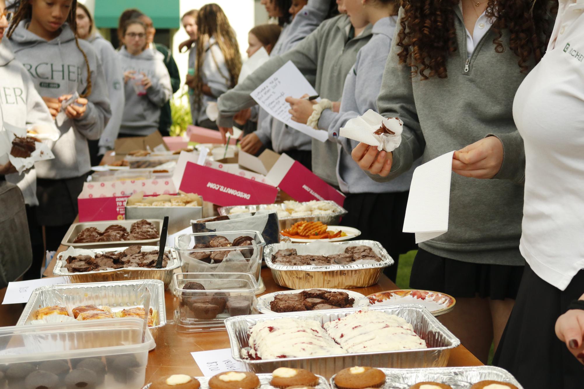 Ninth graders hand out baked goods in the courtyard to Archer students. The ninth grade bake sale took place Friday, Jan. 23, and raised money for the upcoming formal. Many ninth graders chipped in to help out with baking and handing out goods. "We have so much participation from our grade, and the whole school is supporting us," Ninth grade representative Harley Nichols said. "It's really amazing."