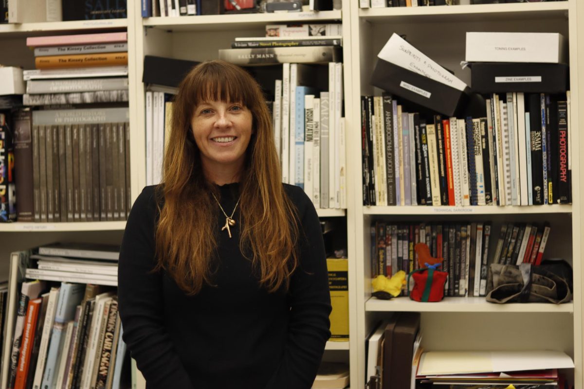 Archer visual arts teacher Marya Alford poses for a photo in the photography classroom. Alford has been at Archer for  eleven years and currently teaches a photography class. "It's so fun to come to school every day and just be able to talk about art" Alford said.