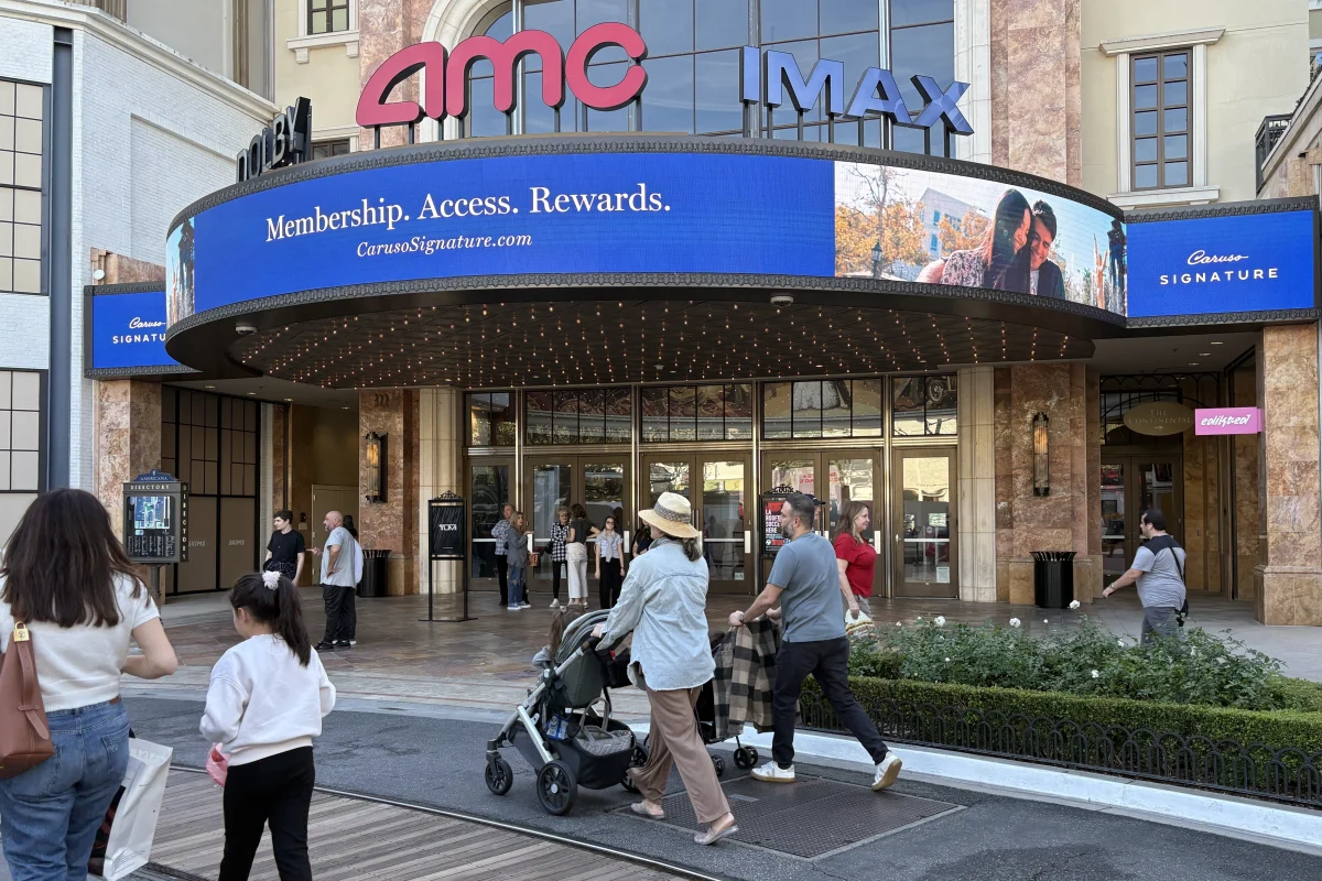 Groups of people stroll past the doors of an AMC theater. The expense of going to theaters is one of the most prevalent barriers for moviegoers today. "It might just end up becoming a very rare occurrence that people go to the movie theaters," Noah Johnson ('26) said. "Or maybe it'll even become a luxury in the future with the way that the prices of movie tickets are going."