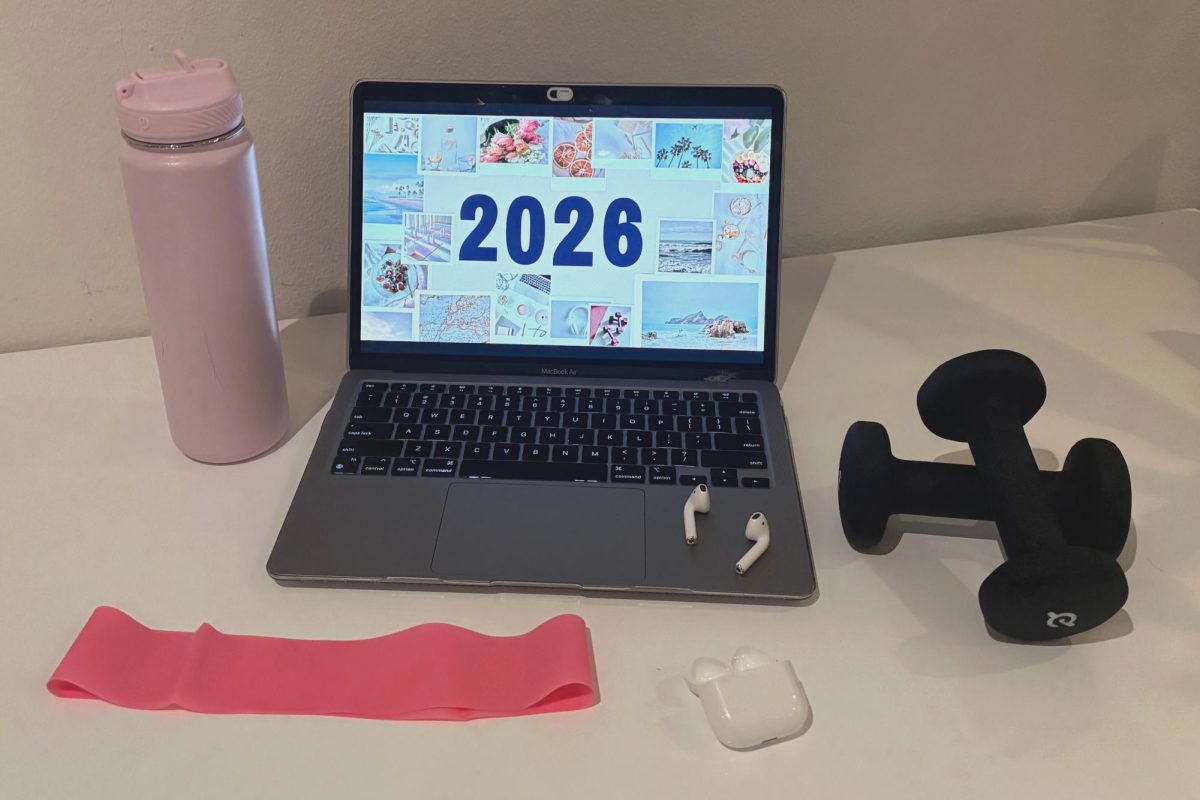 A computer screen displays a vision board for 2026 surrounded by workout equipment, headphones and a water bottle. Creating a vision board is a way to set clear intentions and stay motivated throughout the year. The start of the year is a time to set goals, find balance and build habits to support personal growth.