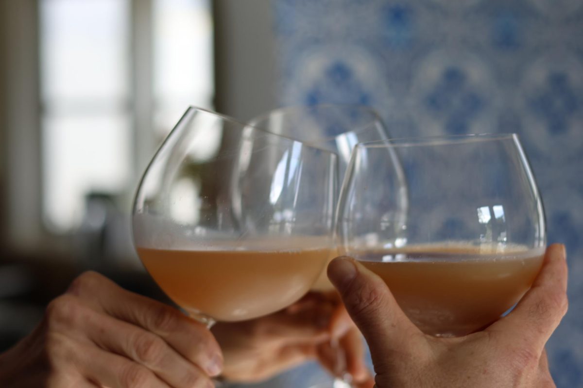 Three wine glasses are raised for a toast in celebration. For people over 21, alcohol can be legally consumed for the purpose of winding down and relaxing, but overconsumption can lead to serious side effects. However, people over 21 are not the only ones drinking, According to the Center for Disease Control and Prevention, around 4,000 minors die from excess drinking each year.