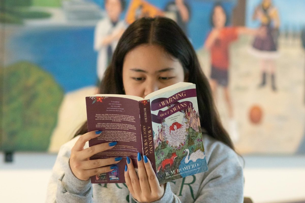Emalee Magno ('29) reads "A Warning About Swans", written by R.M. Romero. "A Warning About Swans" is a YA novel written entirely in verse, interweaving aspects of history, fantasy and mythology to create an enchanting read.