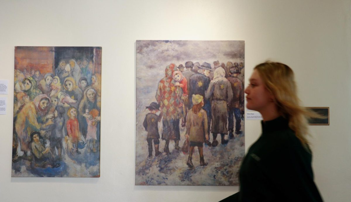 A student passes by David Labkovski's art, which displays his story through the visuals. Labkovski's art paints a picture of his experience throughout the Holocaust, providing a visual example for students to digest.  The Zimmer Gallery opened, displaying his work on Jan. 27.