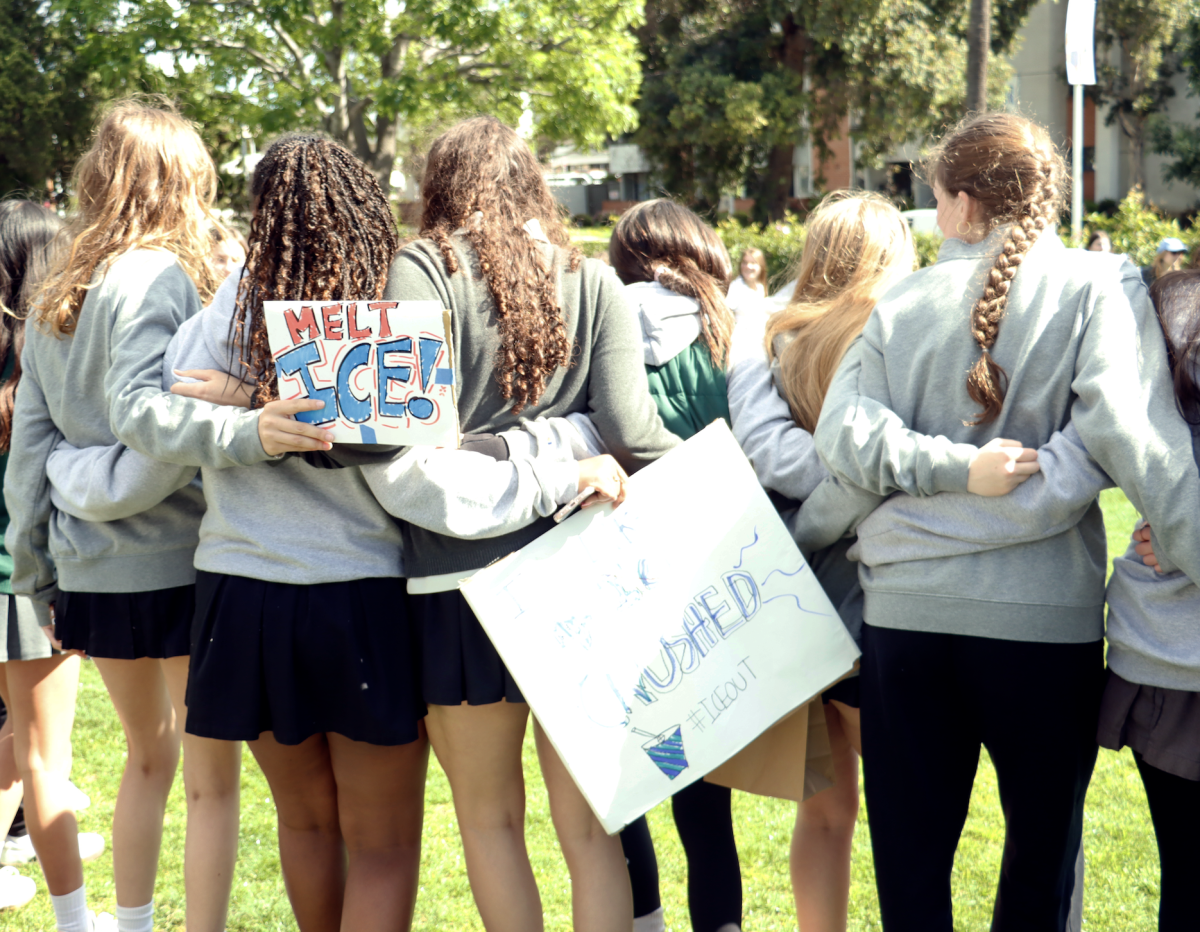Students embrace while holding up signs on the front lawn following the protest. Selam Habtu (‘28) encourages other students to use their voice to speak up for greater issues. “Our voice matters just as much as anyone else,” Habtu said. “When we come together as a community, we can make change.”