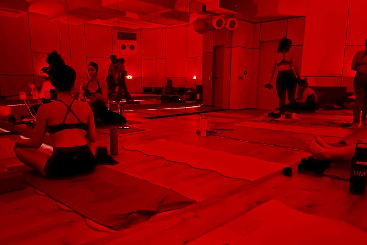 Attendees recover in red light after a yoga sculpt class at Heated Room, a fitness studio with locations in Santa Monica and West Hollywood. Alex Bridwell ('27) is a frequent participant in yoga sculpt classes and said the heated workouts help her feel accomplished. "I feel like if I'm going to go to a class, then I want to get the most out of it,” Bridwell said.