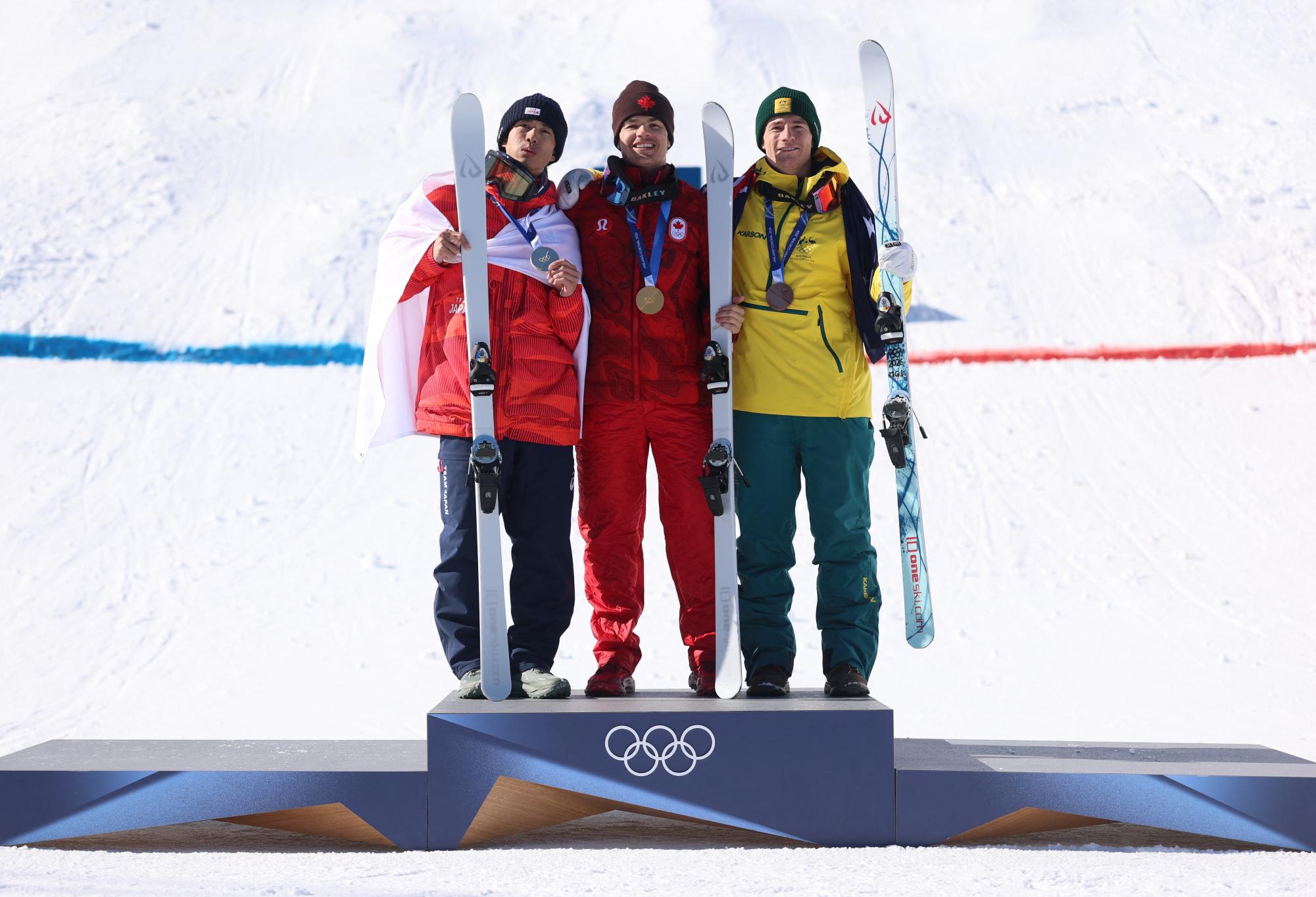 Milano Cortina 2026 Olympics - Freestyle Skiing - Men's Dual Moguls Victory Ceremony - Livigno Aerials & Moguls Park, Livigno, Italy - February 15, 2026. Gold medallist Mikael Kingsbury of Canada celebrates on the podium with silver medallist Ikuma Horishima of Japan and bronze medallist Matt Graham of Australia REUTERS/Hannah Mckay