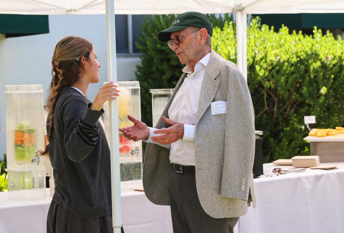 Wearing an Archer-logoed baseball hat, Leonard Sharzer speaks with his granddaughter Sasha Gutrecht ('28) under a tent. Taking place on Thursday, March 19, Grandparents and Special Friends Day allowed students and their guests to watch arts performances and socialize in the courtyard. “Grandchildren are such an important part of their lives,” Associate Director of the Archer Fund Marissa Boyle said. “It’s one thing to hear about the things that happen on campus, but I think it’s a totally different thing to see it in action.”