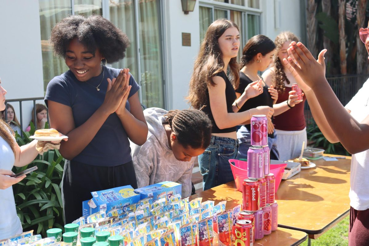 Setting up drinks, freshmen volunteers prepare the Final Friday food table in the courtyard. Ninth grade Student Council representative Harley Nichols ('29) said Final Friday planning required collective grade effort. "People come do their tasks, and they show up," Nichols said. "All of ninth grade is in the courtyard for the Final Friday, just helping out and walking around and just keeping people motivated."