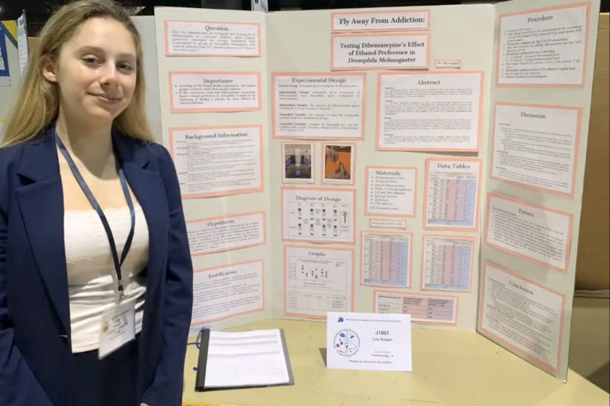 Lilly Swigert ('30) stands with her project from the science fair. Swigert won first place in the pharmacology category, with her research on how dibenzazepine, a chemical, lessens alcohol addiction in fruit flies. "I wanted to be in pharmacology because it's related to medicine and I want to be a doctor when I grow up," Swigert said. "I was looking at a bunch of studies, and I found Dibenzazepine as a very interesting drug that can prevent alcohol addiction." (Photo courtesy of Lilly Swigert)