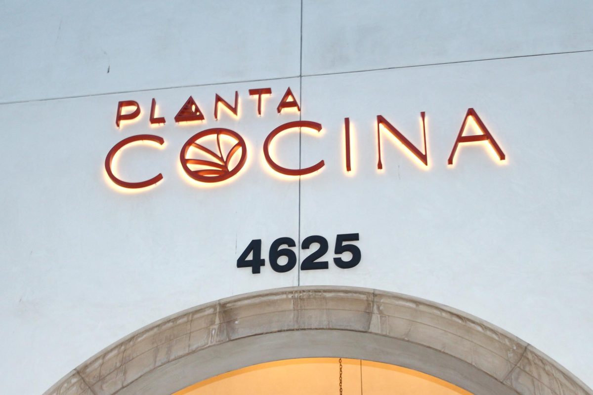 A lit-up sign hangs above a doorway to the restaurant Planta. Planta is a 100% plant-based restaurant serving a mix of Japanese and Mexican-style food. They have multiple locations spanning the continent and Los Angeles, with a diverse menu that's perfect for both picky eaters and foodies. 