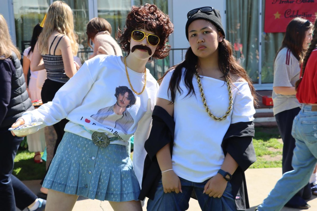 Freshmen Evelyn Brennan and Emalee Magno pose while being dressed as Benson Boone and Ice Cube. Magno said she got the inspiration to dress as Ice Cube because of Thursday's rap competition. Brennan said Benson Boone is her favorite artist, especially after going to his concert last year. "I really think it brightens up the week, especially when we're looking foward to spring break, but it seems so far away," Brennan said. 