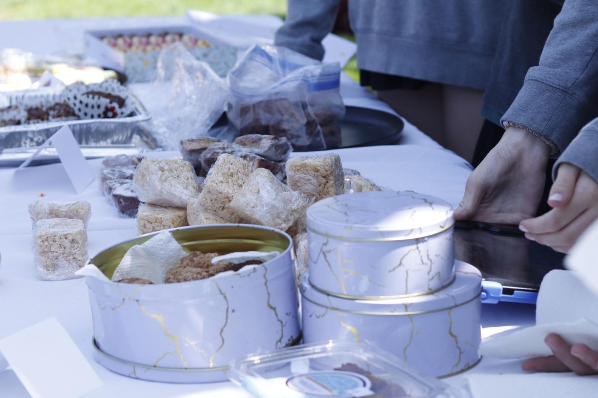 An assortment of baked goods — including Rice Krispies treats, brownies and cookies — is displayed on a table for students to purchase. The For Goodness Cakes bake sale occurred Friday, April 17, and raised funds to support foster youth.