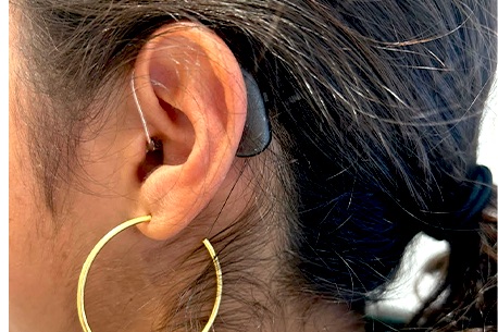 Liana Awai (‘29) shows her ear with her hearing aid attatched. Hearing aids amplify sound for those with partial hearing loss to hear sound more clearly. “At first I was hesitant because I just didn't want to get hearing aids, but I am so glad I did,” Awai said. “I felt proud that I could finally hear and understand and listen.”
