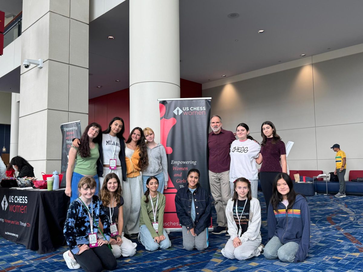 The chess team, which is made up of middle and upper school players, smiles as they stand in front of the national tournament banner. From April 10–12, the team traveled to Chicago for the All‑Girls National Chess Tournament. For senior Morgan McClinton, the experience highlighted the value of having access to programs like chess. “Archer, offering all of these clubs, shows people other things they can do in the world and with their lives and with their time,” McClinton said. (Photo courtesy of Morgan McClinton) 