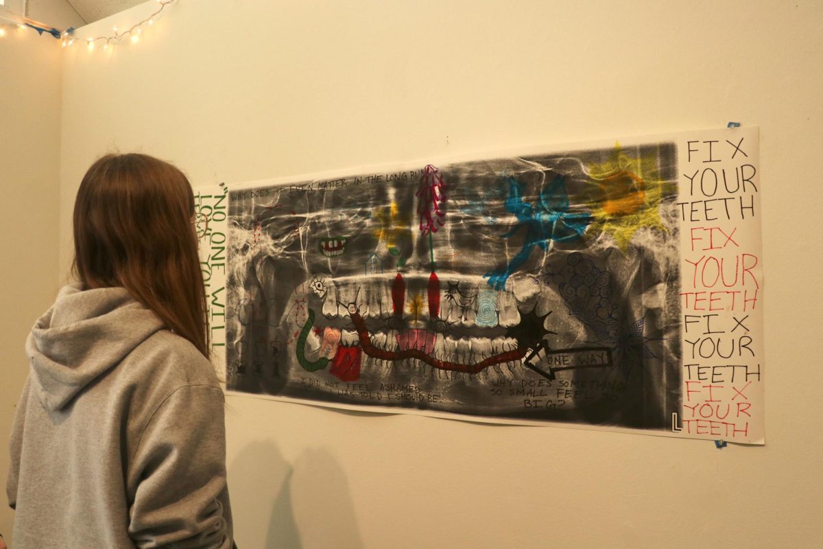 Phoebe Gustafson ('27) stands before Speck's piece.