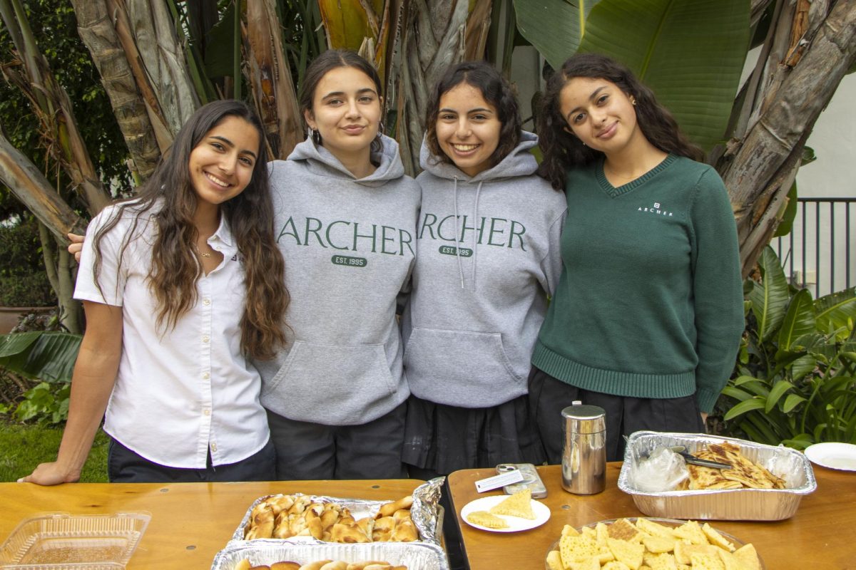 Members of the Middle East and North Africa club pause their potluck setup to pose for a photo. Sarah Mzoughi ('28) brought traditional Morrocan fare for students to try. "We hosted a potluck serving Arab foods ranging from sweets to savory treats to even drinks," Mzoughi said. "It was really nice to interact with the community and share parts of our culture.”